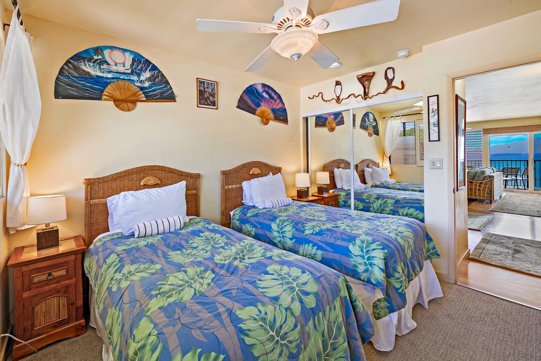 3559 Lower Honoapiilani Road, Unit 5G Lahaina, HI 96761 - Photo 29 of 42 a bedroom with two beds and painting on the wall