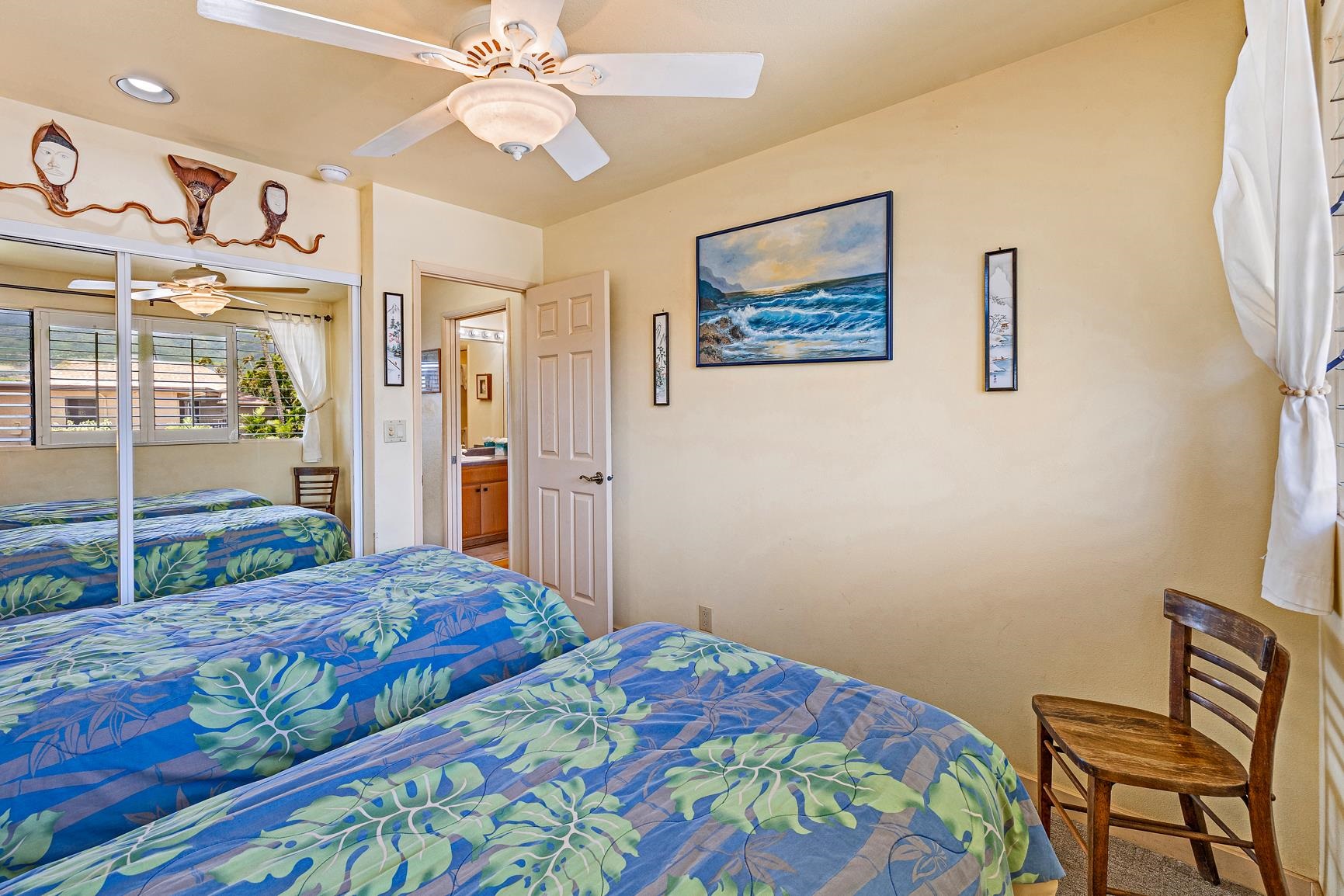 3559 Lower Honoapiilani Road, Unit 5G Lahaina, HI 96761 - Photo 30 of 42 a bedroom with a bed and a chandelier