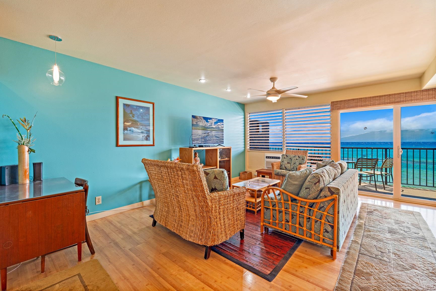 3559 Lower Honoapiilani Road, Unit 5G Lahaina, HI 96761 - Photo 8 of 42 a living room with furniture a large window and a flat screen tv