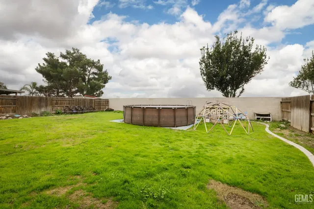 an aerial view of a house with swimming pool garden and patio