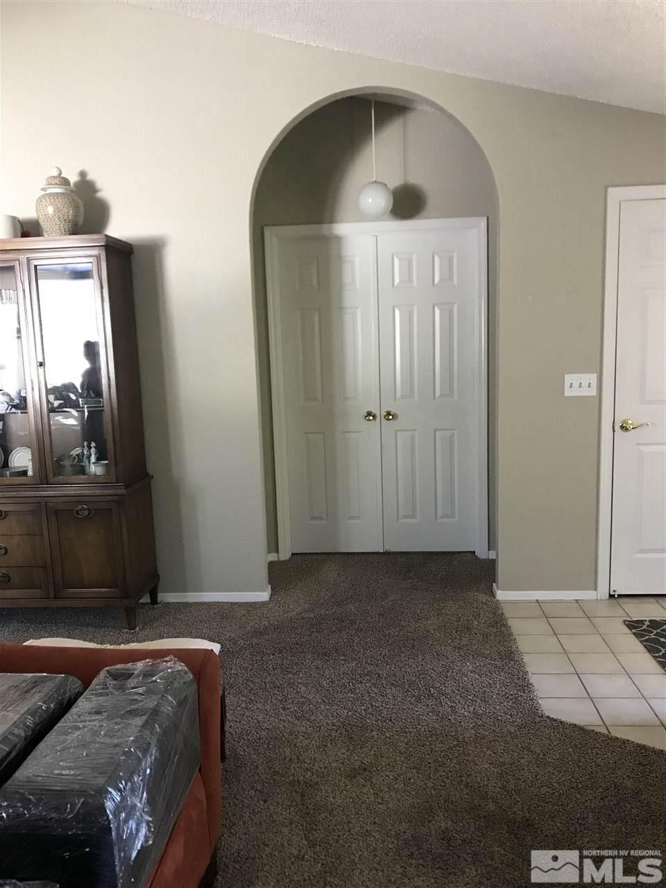 5305 Vista Ridge Way Reno, NV 89523 - Photo 4 of 11 a bedroom with a bed and a mirror