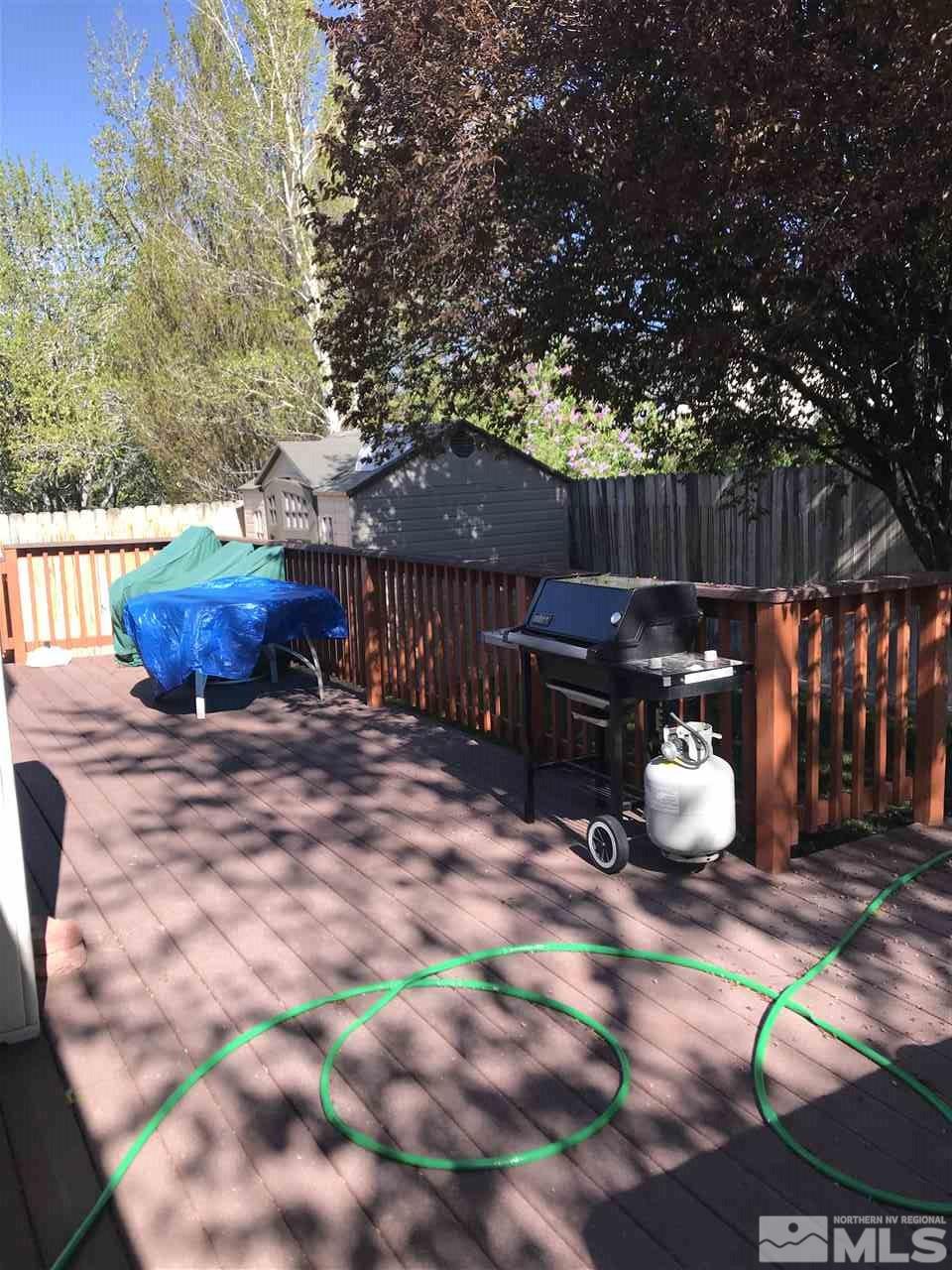 5305 Vista Ridge Way Reno, NV 89523 - Photo 9 of 11 a view of a backyard with table and chairs potted plants and wooden fence