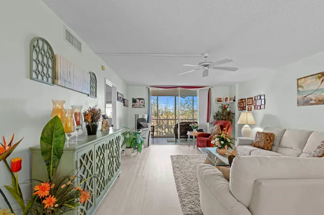 a living room with furniture and a floor to ceiling window