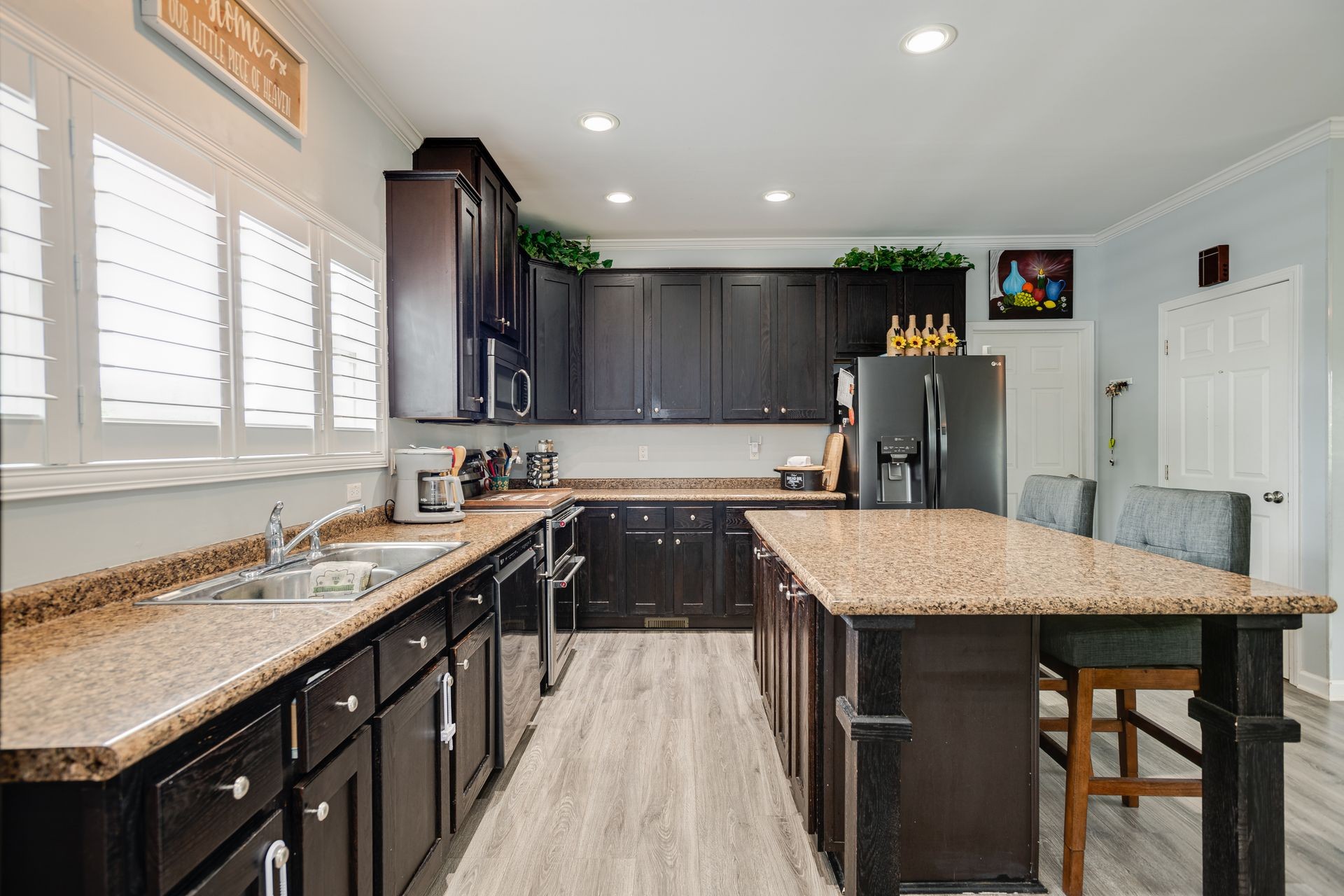 3321 Mahlon Moore Road Spring Hill, TN 37174 - Photo 10 of 22 a kitchen with kitchen island granite countertop a sink stove and refrigerator