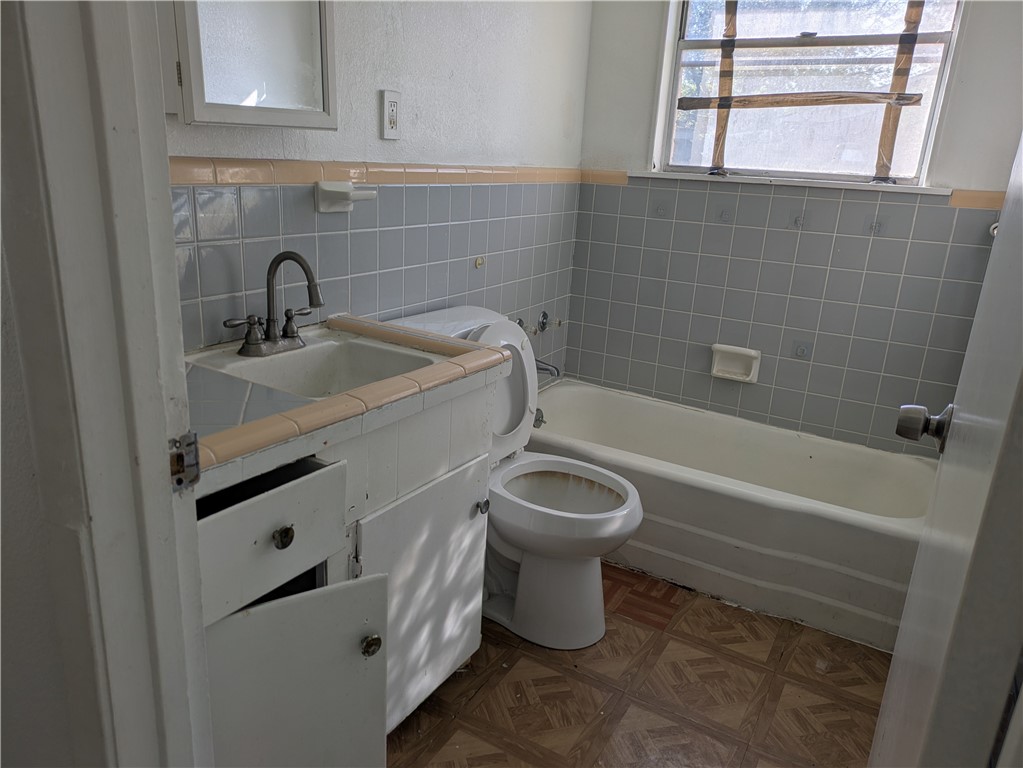 124 Redwood Drive Mathis, TX 78368 - Photo 7 of 10 a bathroom with a sink a toilet and bathtub
