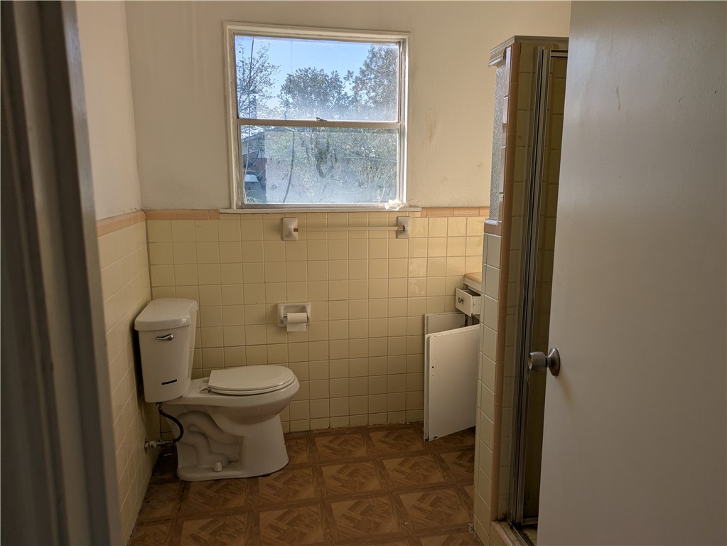 124 Redwood Drive Mathis, TX 78368 - Photo 8 of 10 a bathroom with a toilet and a shower