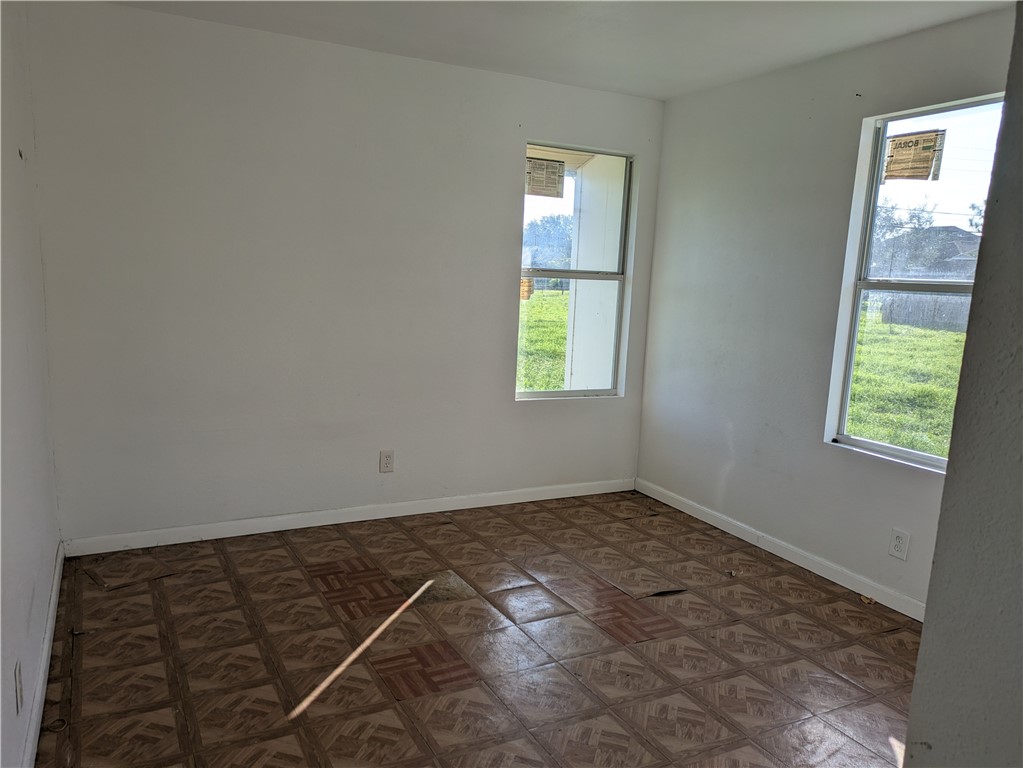124 Redwood Drive Mathis, TX 78368 - Photo 9 of 10 an empty room with windows
