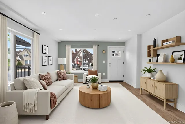 a living room with furniture and a potted plant