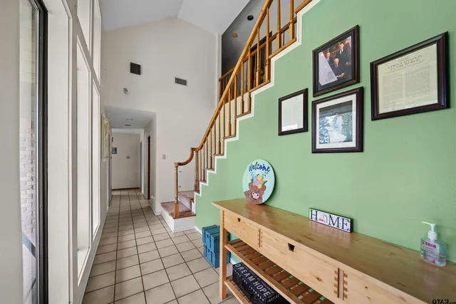 a spacious bathroom with a double vanity sink a mirror and a