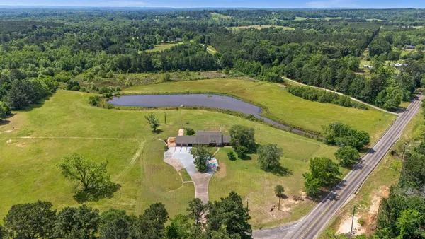 a aerial view of a house with pool garden view and lake view