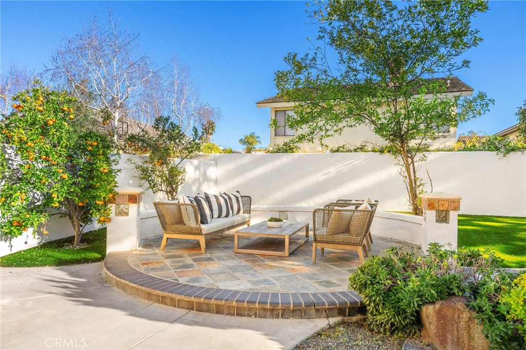 6 Broadleaf Irvine, CA 92612 - Photo 12 of 46 a view of a backyard with table and chairs potted plants and large tree