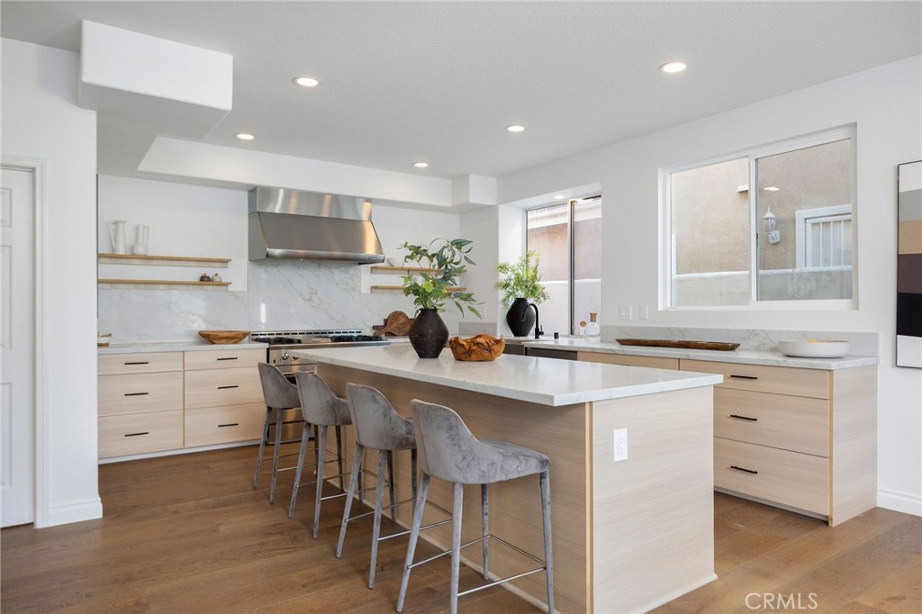 6 Broadleaf Irvine, CA 92612 - Photo 18 of 46 a kitchen with white cabinets and chairs