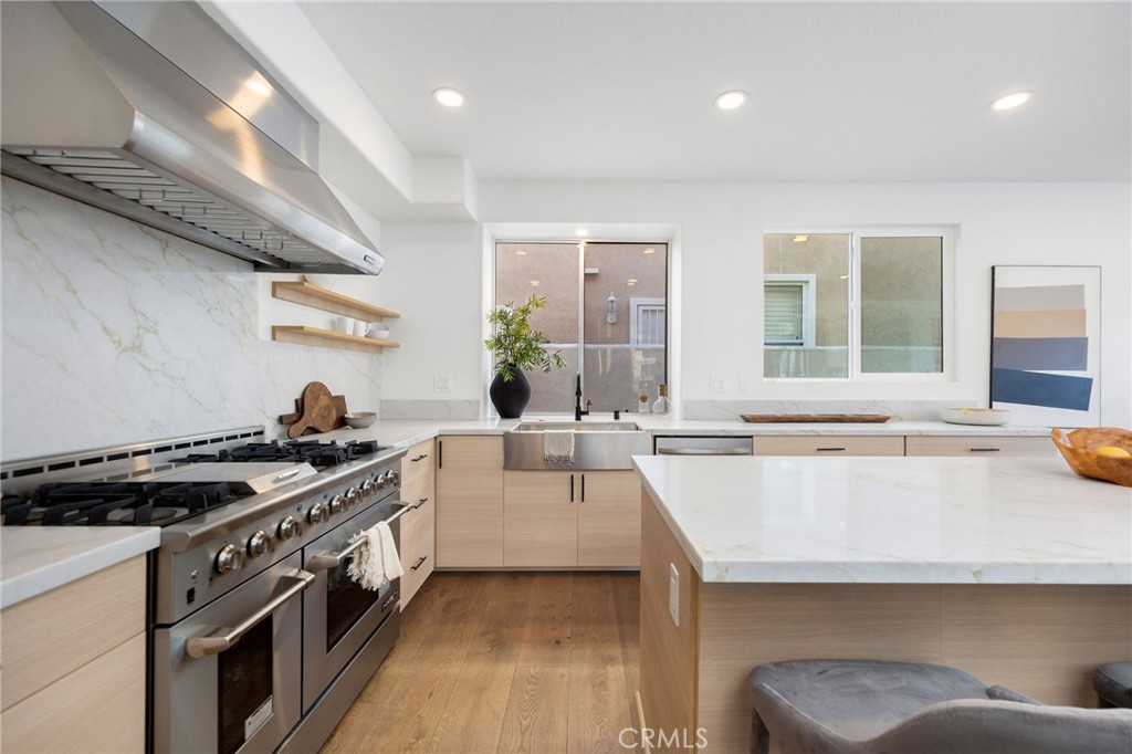 6 Broadleaf Irvine, CA 92612 - Photo 19 of 46 a kitchen with a sink a stove and chairs
