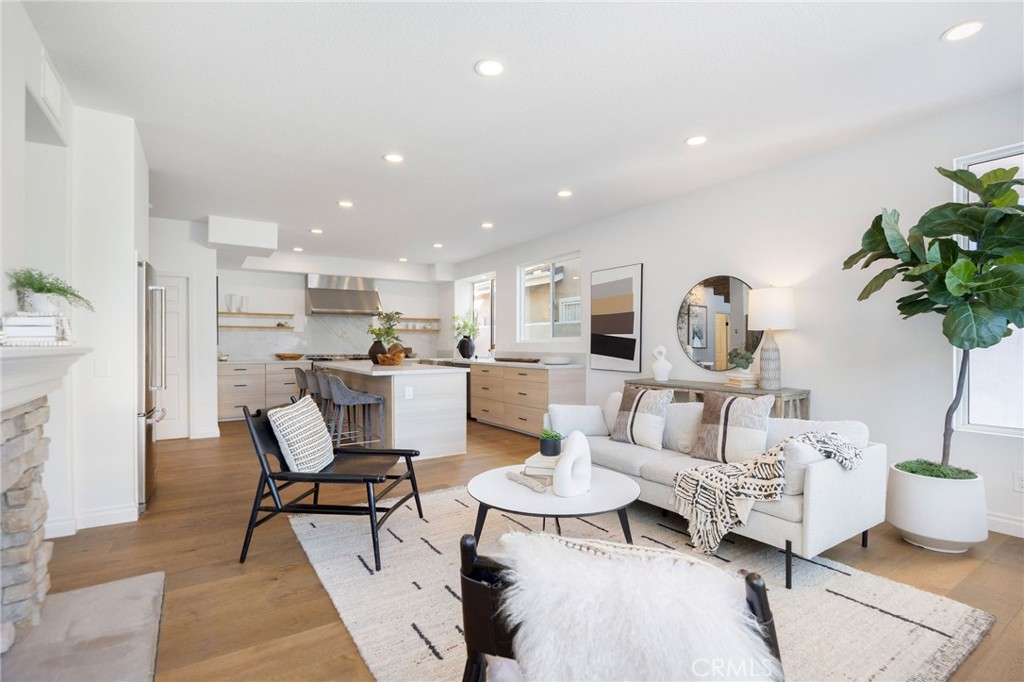 6 Broadleaf Irvine, CA 92612 - Photo 20 of 46 a living room with furniture and a dining table with kitchen view