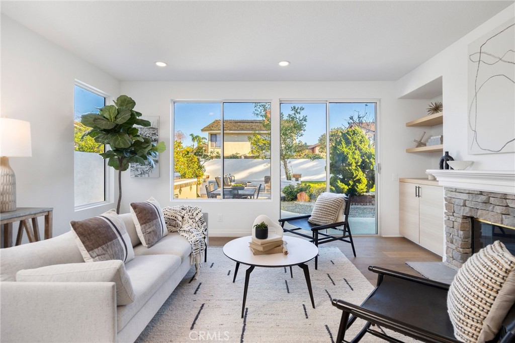 6 Broadleaf Irvine, CA 92612 - Photo 21 of 46 a living room with furniture a fireplace and a potted plant