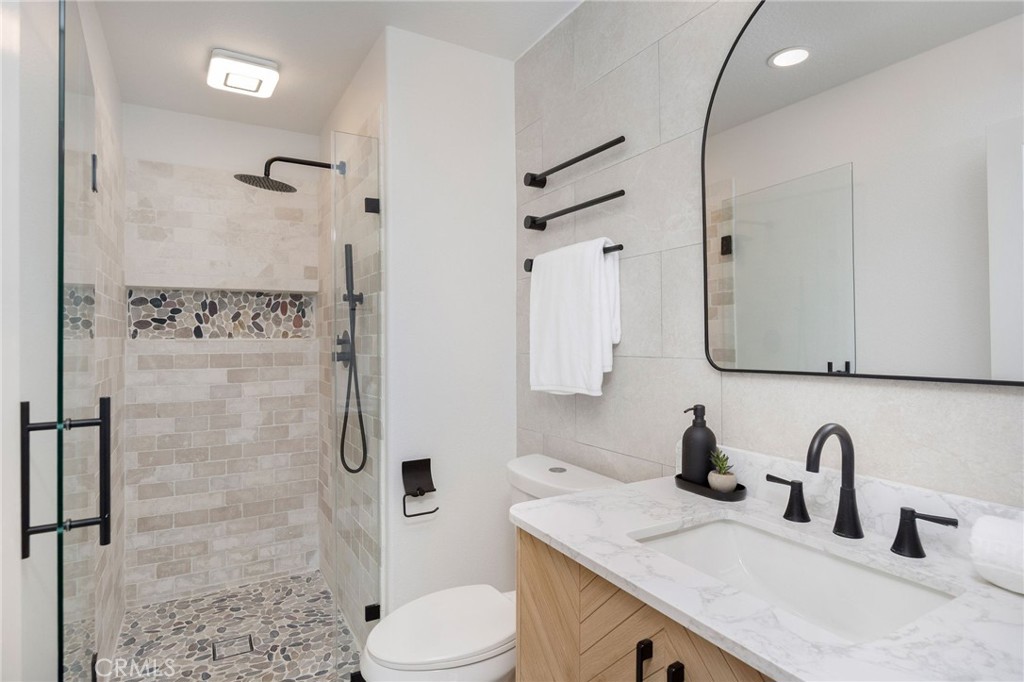 6 Broadleaf Irvine, CA 92612 - Photo 22 of 46 a bathroom with a granite countertop sink toilet and shower