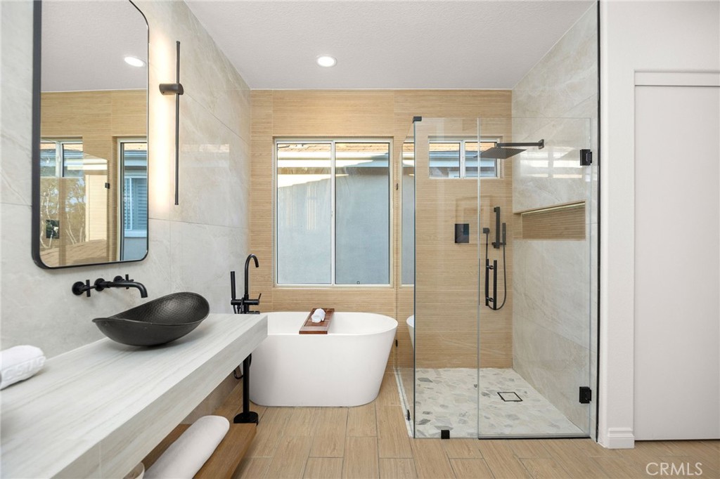 6 Broadleaf Irvine, CA 92612 - Photo 26 of 46 a bathroom with a tub sink and mirror