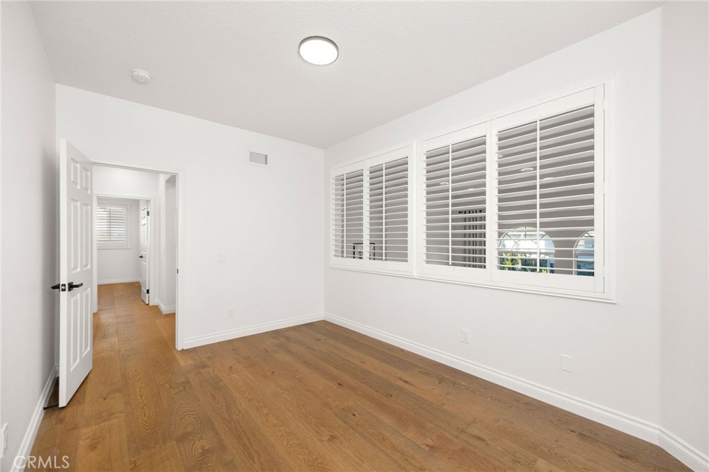 6 Broadleaf Irvine, CA 92612 - Photo 29 of 46 a view of an empty room with wooden floor and a window