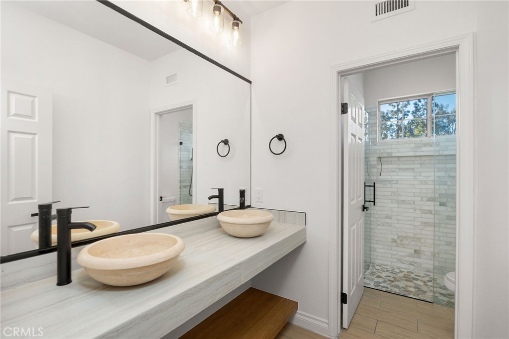 6 Broadleaf Irvine, CA 92612 - Photo 32 of 46 a bathroom with a granite countertop sink a toilet and shower