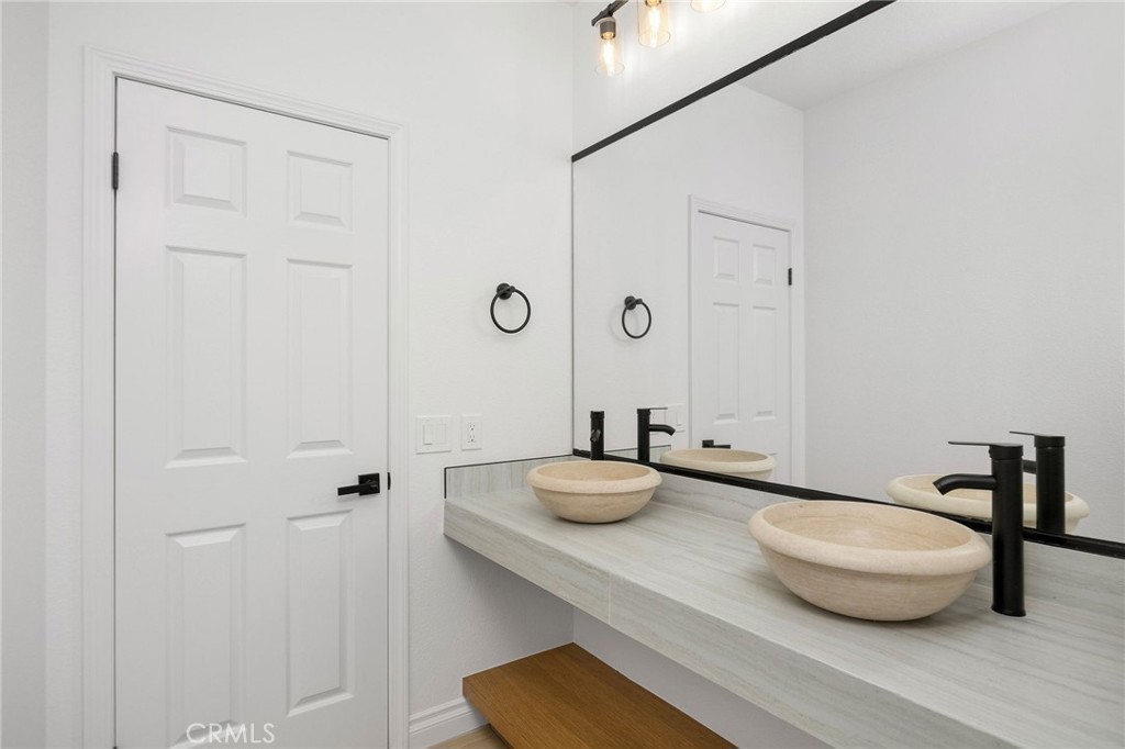 6 Broadleaf Irvine, CA 92612 - Photo 34 of 46 a bathroom with a granite countertop sink and a mirror