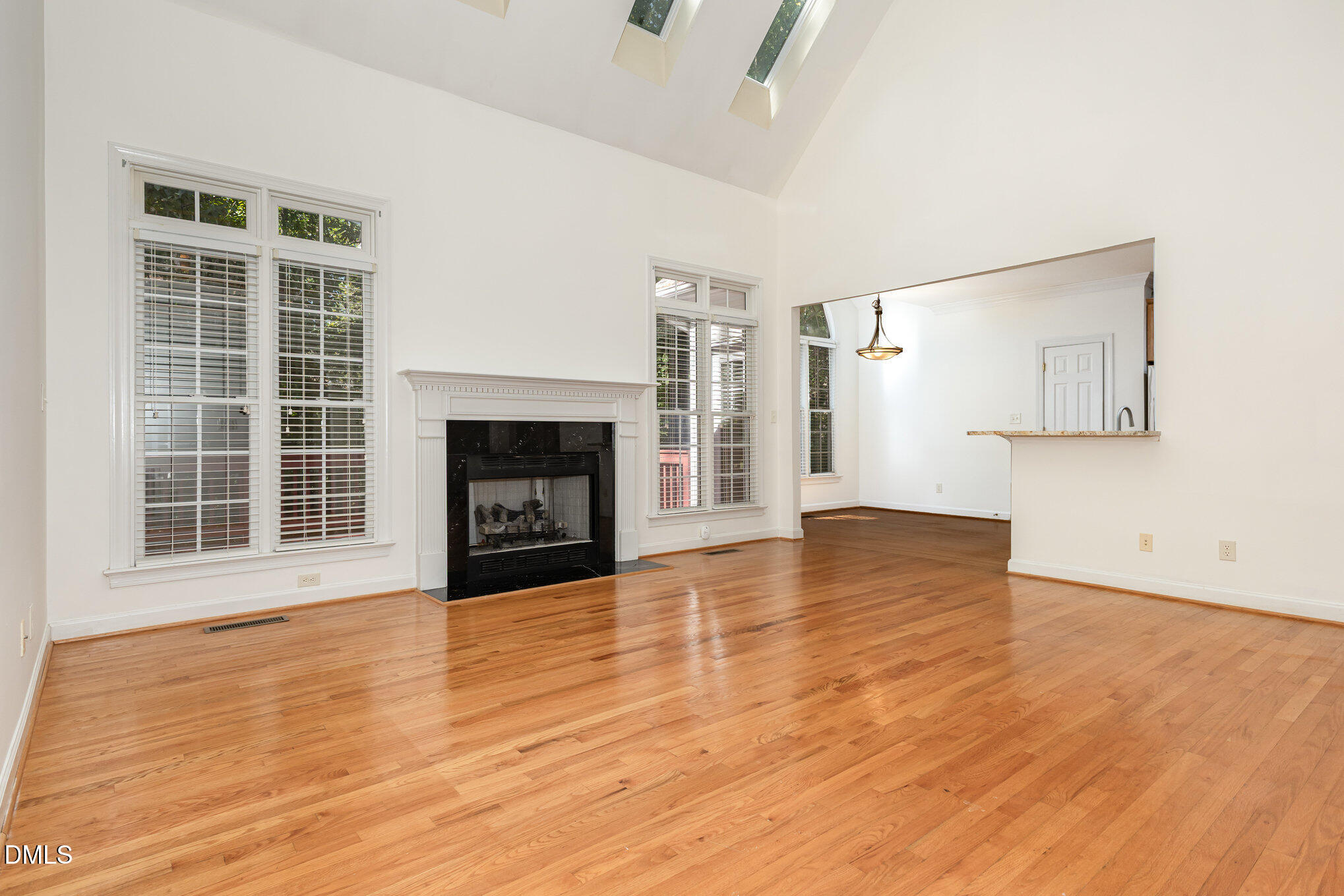 209 Manor Ridge Road Carrboro, NC 27510 - Photo 9 of 39 a view of empty room with wooden floor and fireplace