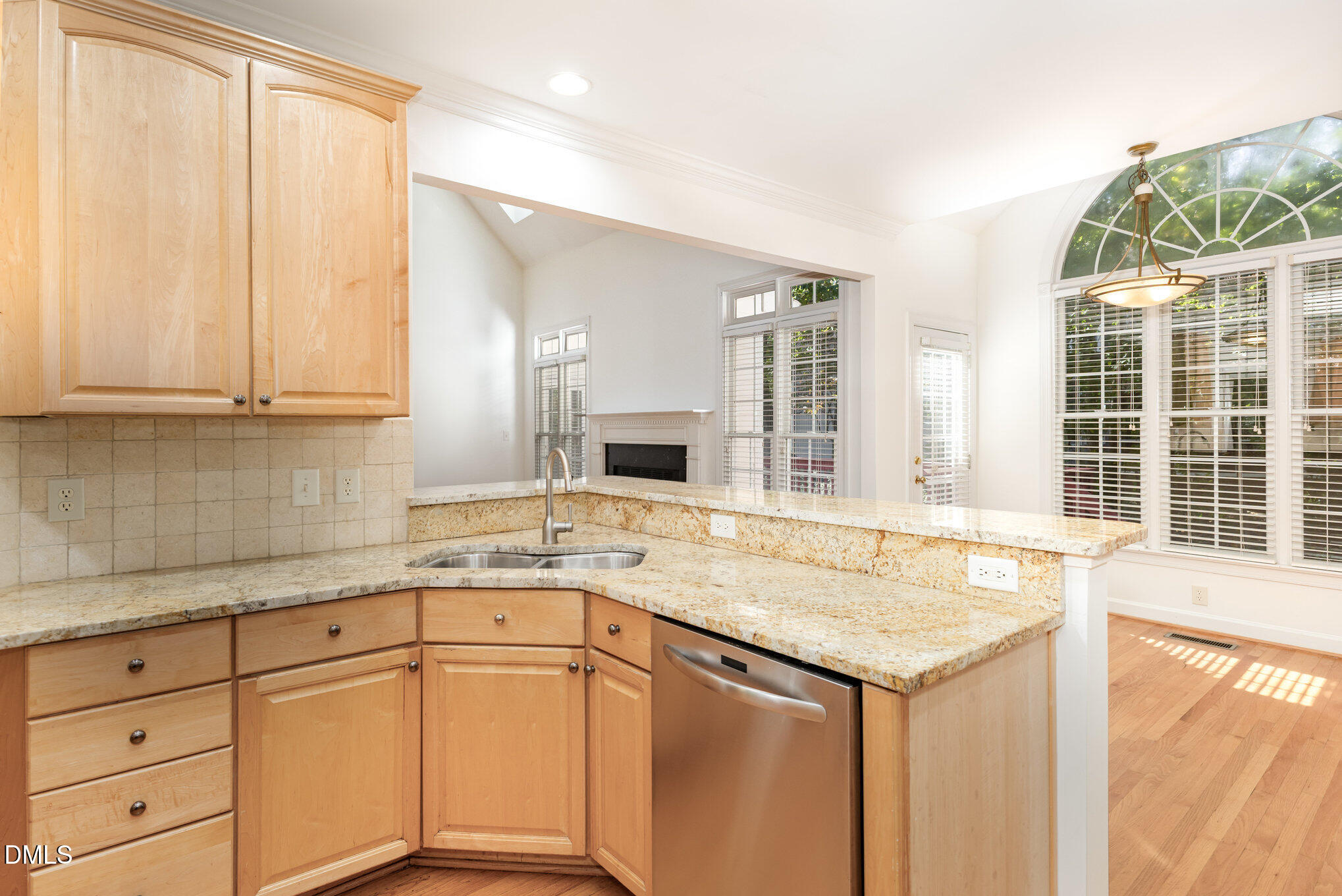 209 Manor Ridge Road Carrboro, NC 27510 - Photo 13 of 39 a kitchen with stainless steel appliances granite countertop a sink and dishwasher with wooden cabinets