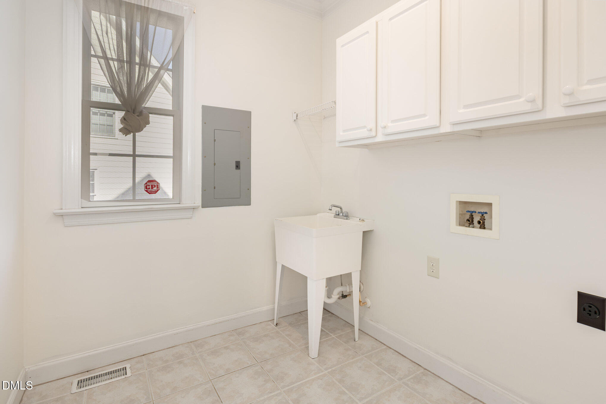 209 Manor Ridge Road Carrboro, NC 27510 - Photo 14 of 39 a view of cabinets and utility room with a window