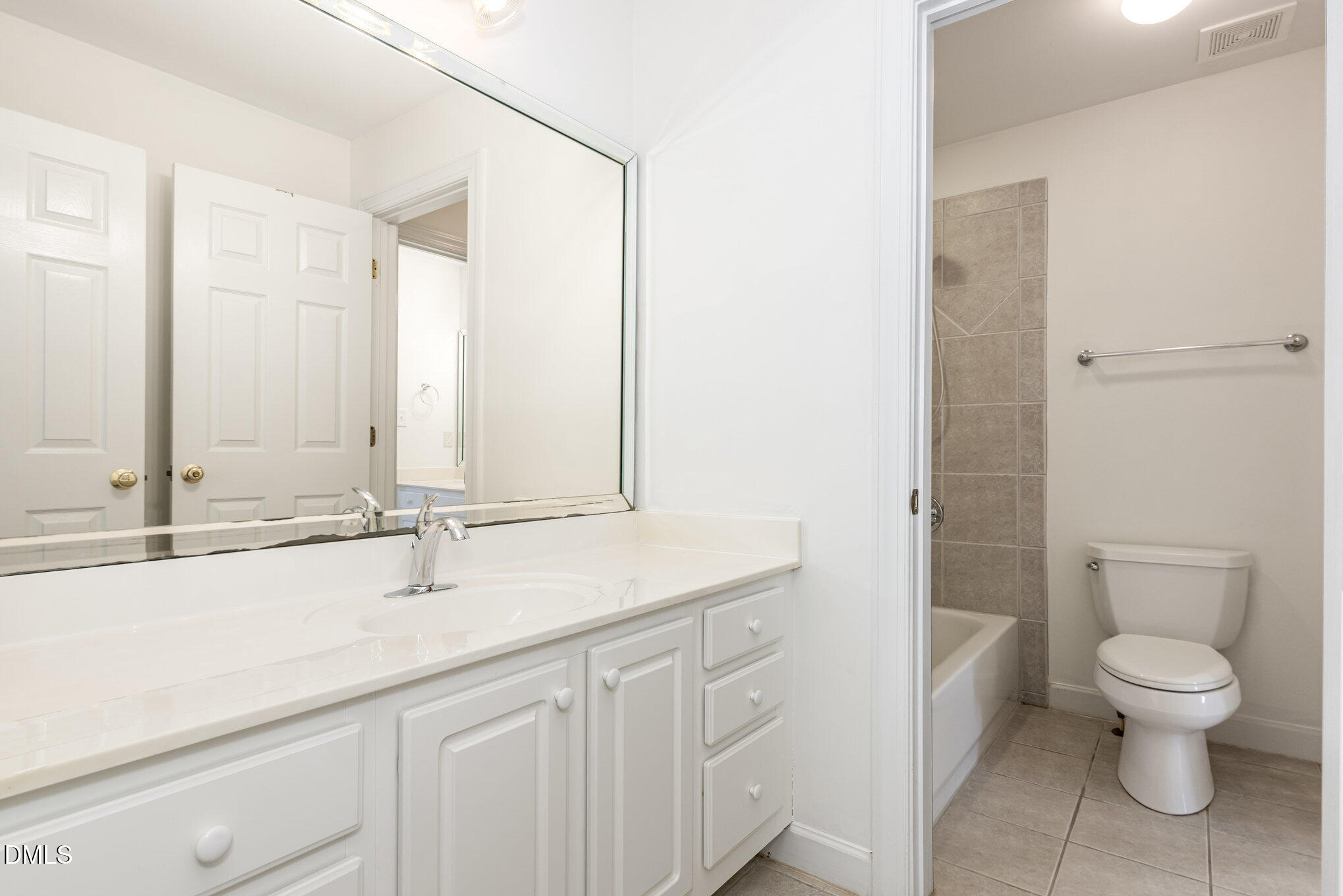 209 Manor Ridge Road Carrboro, NC 27510 - Photo 26 of 39 a bathroom with a granite countertop sink a toilet and a mirror