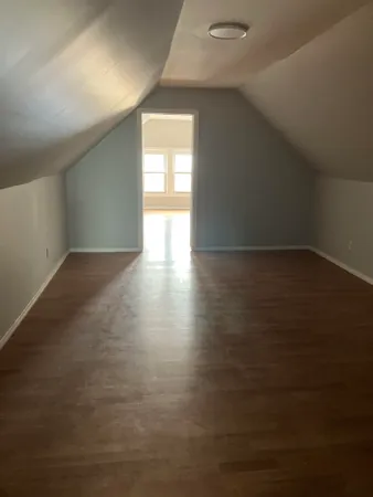 a view of an empty room and a window