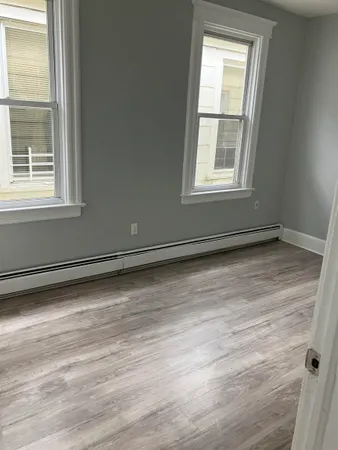 a view of a room with wooden floor and windows