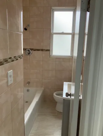 a bathroom with a bathtub and window