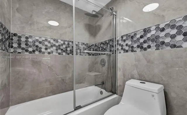 a bathroom with a shower and a toilet