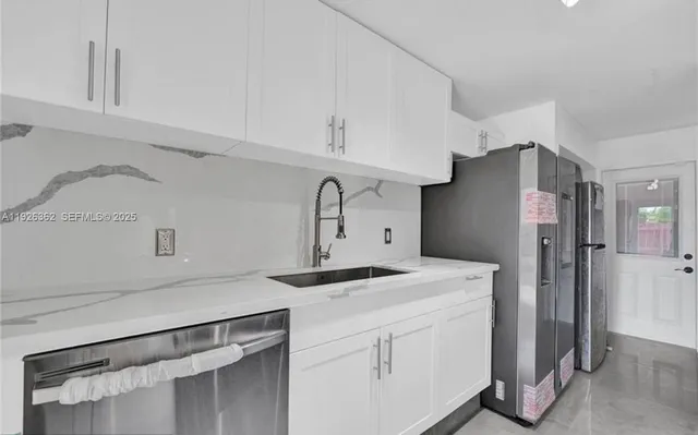 a kitchen with cabinets appliances and a counter space