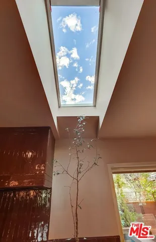 a backyard of a house with yard fountain and outdoor seating