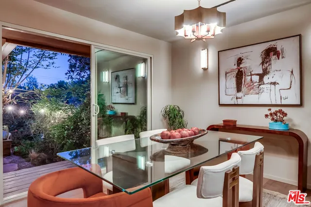 a bathroom with a granite countertop toilet a sink and a mirror