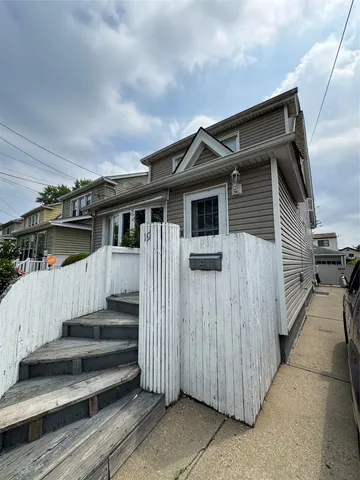 a view of a house with wooden fence