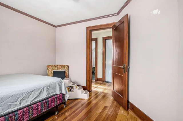 a bedroom with a bed and a mirror