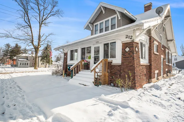 a view of a building with snow on the road