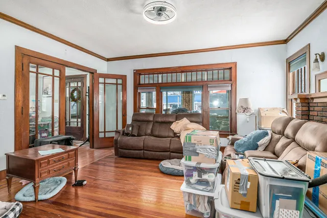 a living room with fireplace furniture and floor to ceiling windows