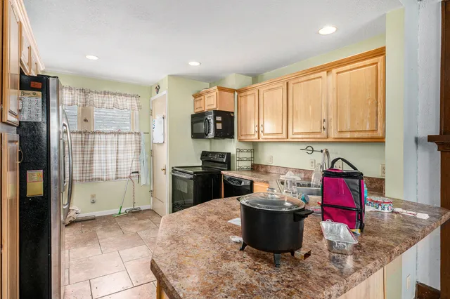a kitchen with a stove a sink and a refrigerator