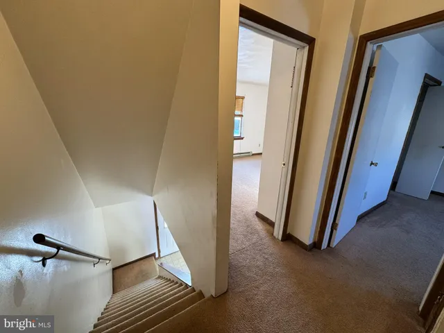 a view of a hallway with staircase