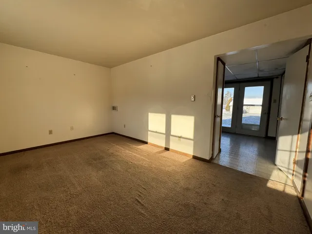 a view of a livingroom with wooden floor and a window
