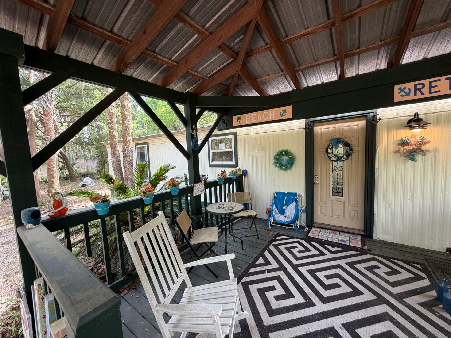 a balcony view with couple of chairs and wooden roof