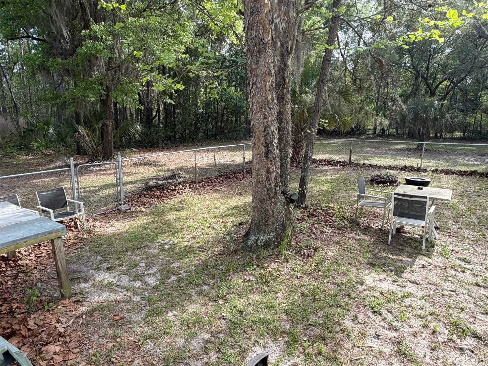 85045 Lonnie Crews Road Fernandina Beach, FL 32034 - Photo 26 of 28 a backyard of a house with table and chairs