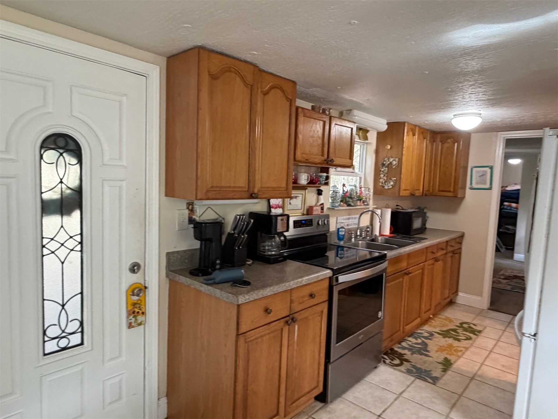 85045 Lonnie Crews Road Fernandina Beach, FL 32034 - Photo 9 of 28 a kitchen with stainless steel appliances granite countertop a stove a sink and a refrigerator