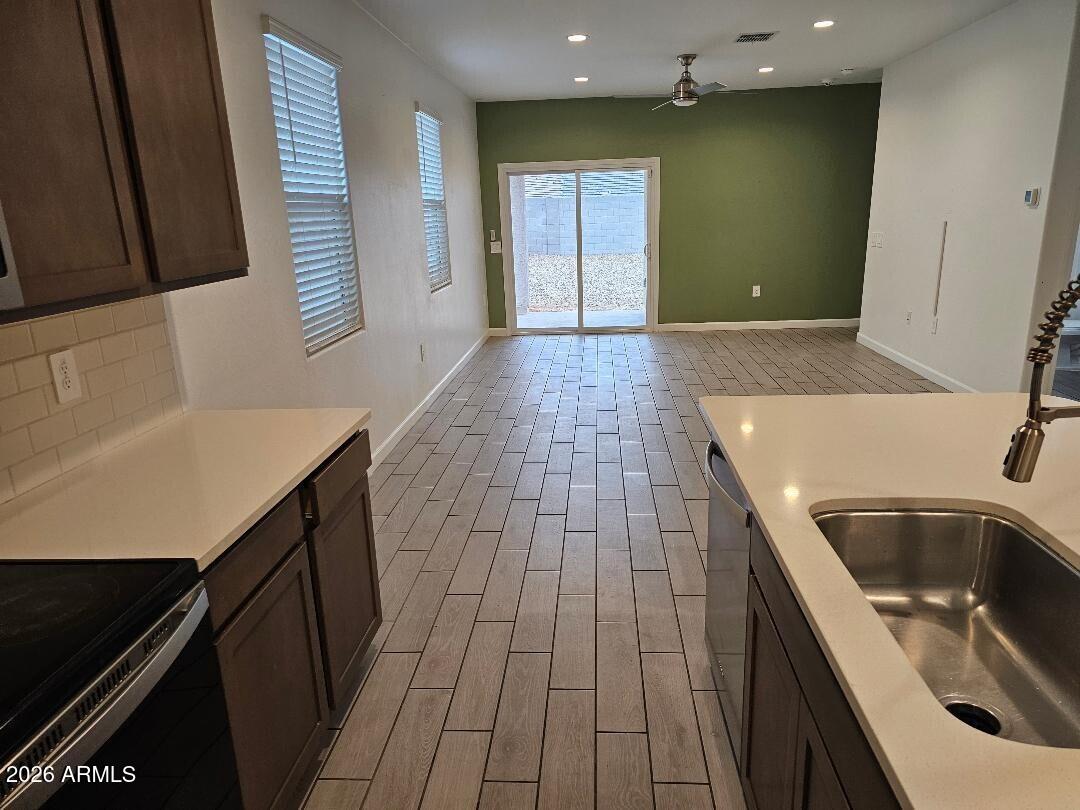 24151 West Ripple Road Buckeye, AZ 85326 - Photo 2 of 13 a kitchen with a sink and a refrigerator