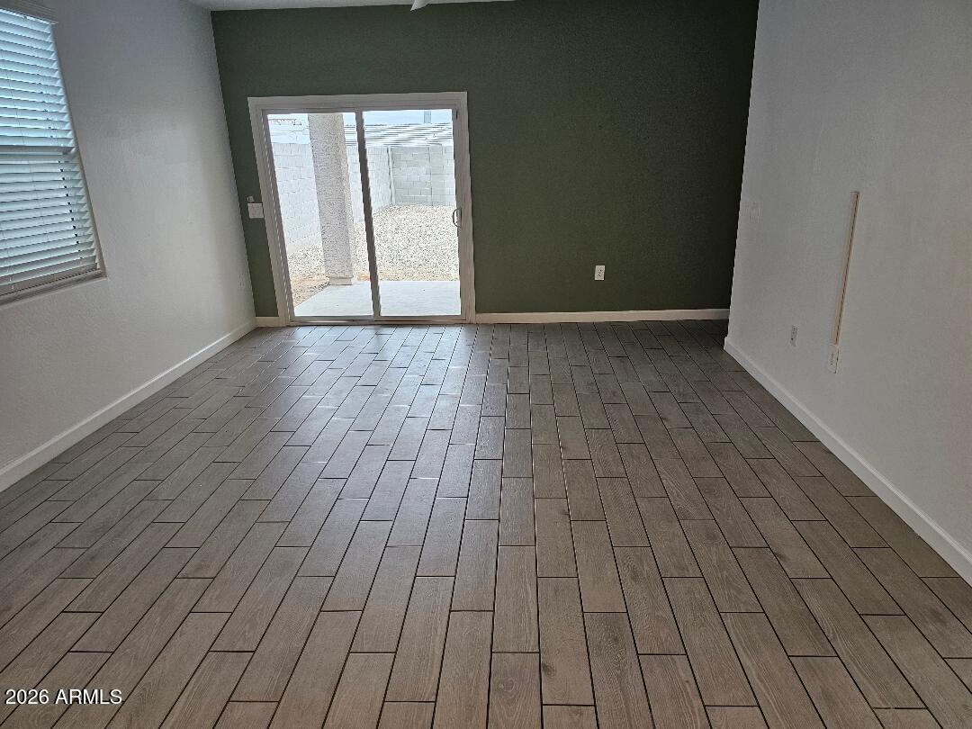24151 West Ripple Road Buckeye, AZ 85326 - Photo 3 of 13 a view of empty room with wooden floor