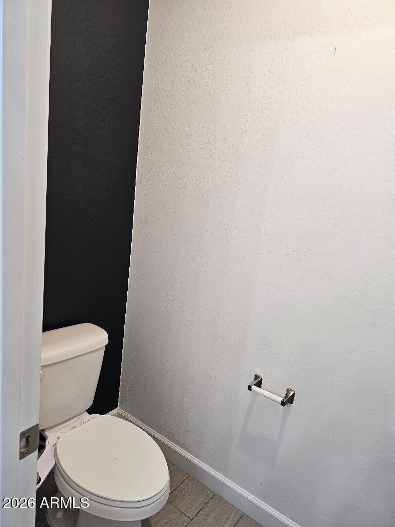 24151 West Ripple Road Buckeye, AZ 85326 - Photo 8 of 13 a white toilet sitting next to a shower