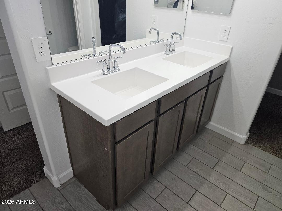 24151 West Ripple Road Buckeye, AZ 85326 - Photo 9 of 13 a bathroom with a sink and a mirror