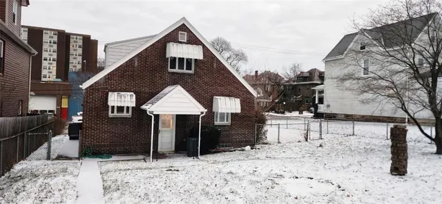 a view of a house with a yard covered in snow